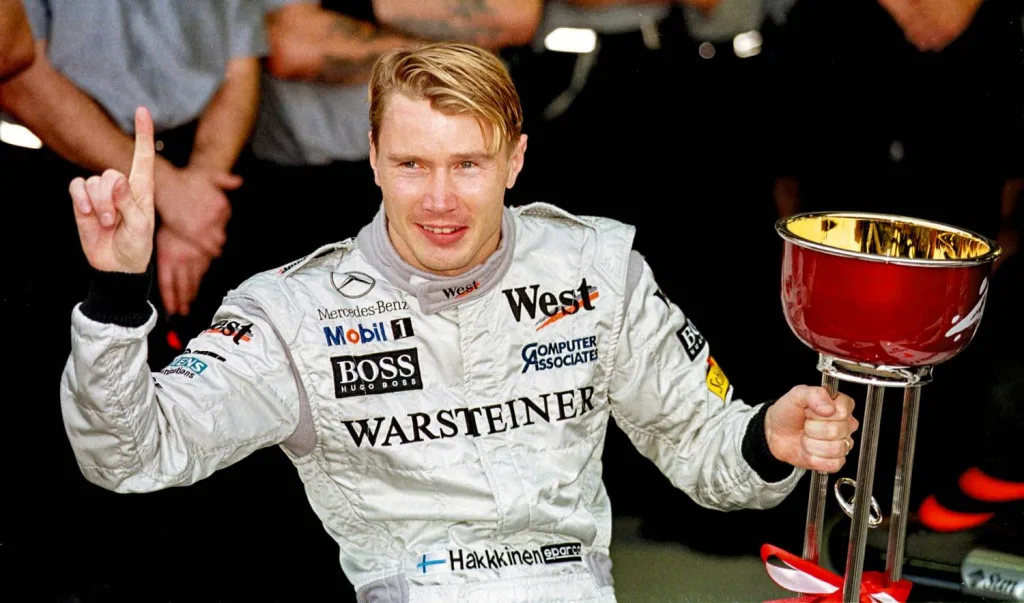 Mika Häkkinen, photo of the victory ceremony of the 1998 Japanese Grand Prix. Häkkinen wins the race, third place goes to his teammate David Coulthard. The Finnish racing driver wins his second consecutive Formula 1 Drivers’ World Championship title with McLaren-Mercedes in 1998. (Photo index number in the Mercedes-Benz Classic Archives: 2001DIG317)